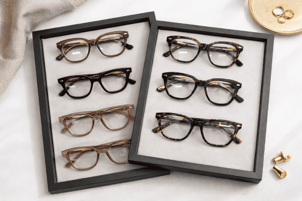 Luxury eyewear display with elegant accessories1 a tray of Ahlem luxury eyewear with gold accessories