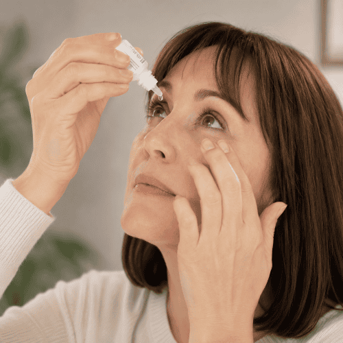 lady instilling drops for dry eye Lady instilling drops for dry eye
